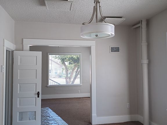 Living room to dining room. The door on the left goes to the basement.