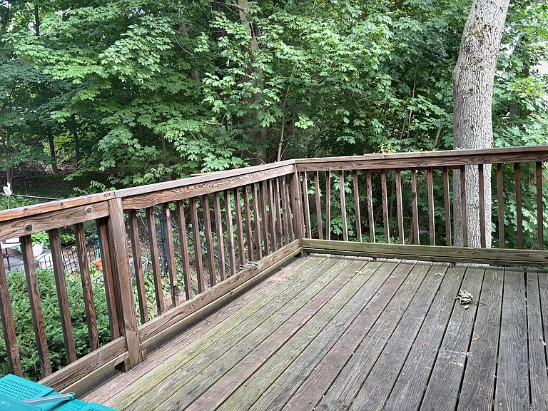 Large private deck overlooking owner's back yard. Lots of green space. Deck large enough to put outdoor sofas or dinning room table.