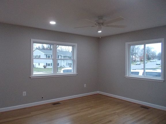 Living Room with hardwood flooring and plenty of windows