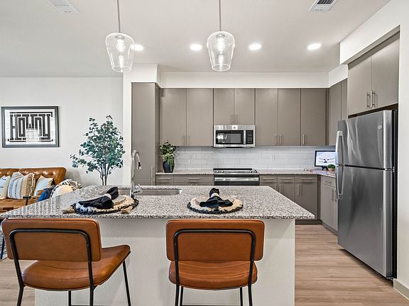Stainless Steel Appliances and Gray Cabinets