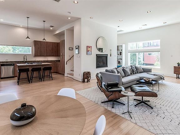 Open LR/DR/Kitchen has 11' ceilings, bamboo floors, & recessed lighting! In-wall gaslog fireplace! Amazing natural light comes in through windows on 3 sides! Living/Dining is approximately 29'x17' (Buyer to verify) and allows for flexible furniture a
