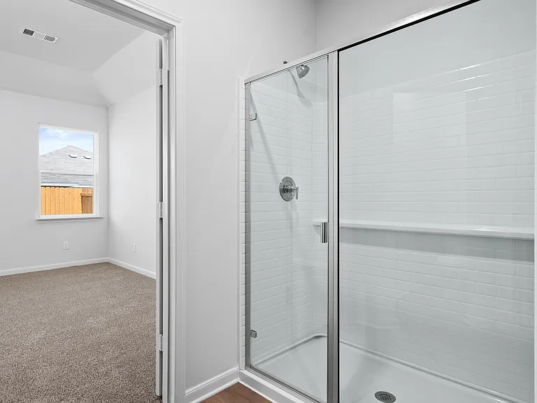 The master bathroom has a glass, walk-in shower.