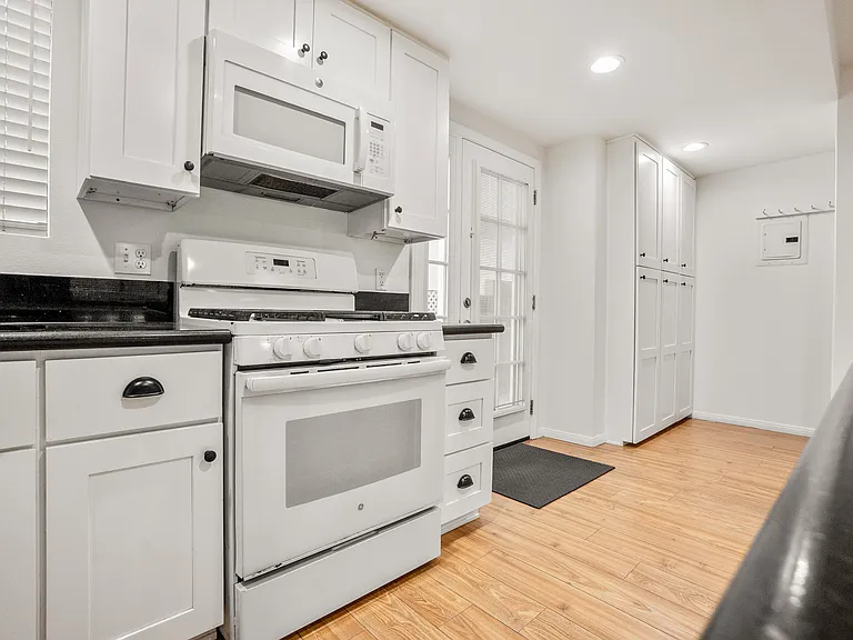 Full Kitchen with dishwasher next to the sink.
