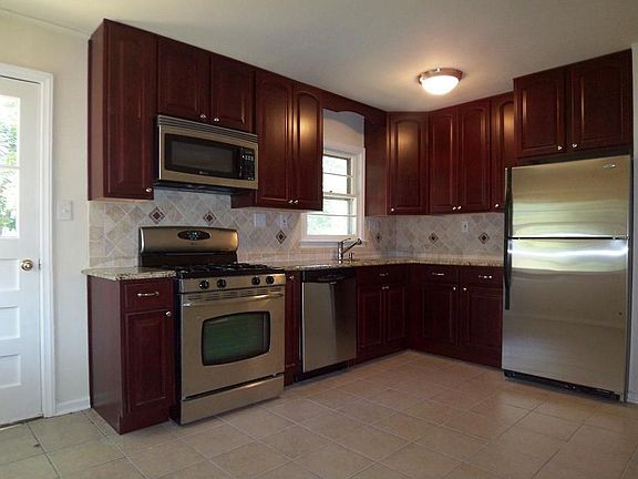 Eat-in kitchen with granite counters, tumbled marble backsplash, SS appliances