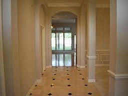 Grand entry with marble and granite inlay features soaring ceilings and arched doorways.