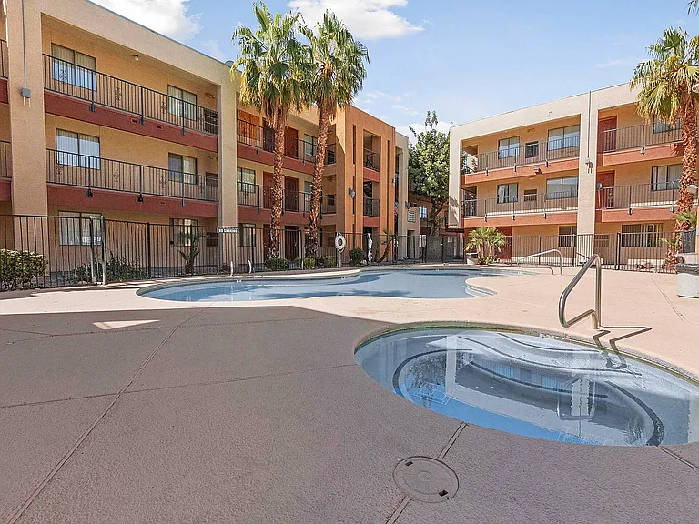 Relax by the pool in this serene apartment courtyard, offering a perfect blend of leisure and style.