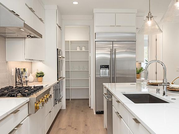 Well-designed kitchen with plenty of cabinet storage plus a walk-in pantry