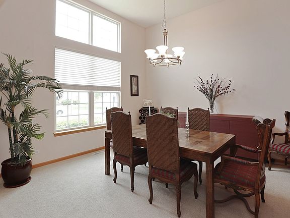 Two 9' sets of windows, with Custom Shades, Bathe Dining Room and Foyer in Natural Light