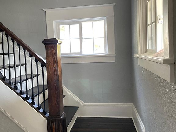 Stairs leading upstairs to the bedrooms and one of the bathrooms.