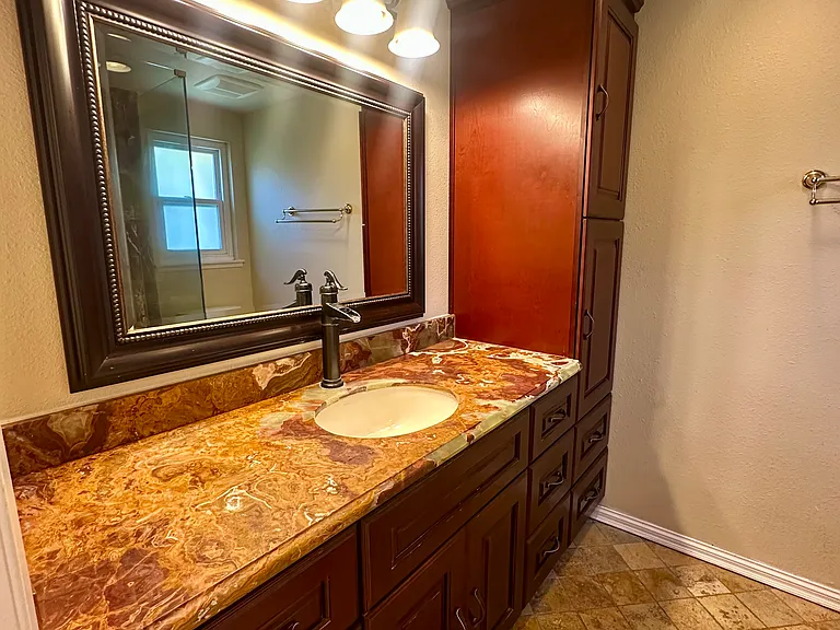 Primary vanity wit Onyx stone counter and plenty of storage