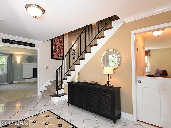 Large Foyer Leading to Sconce Lighted Stairway