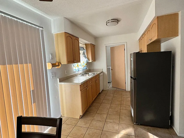 Kitchen from dining area. Past the kitchen is the laundry room with access to the backyard!