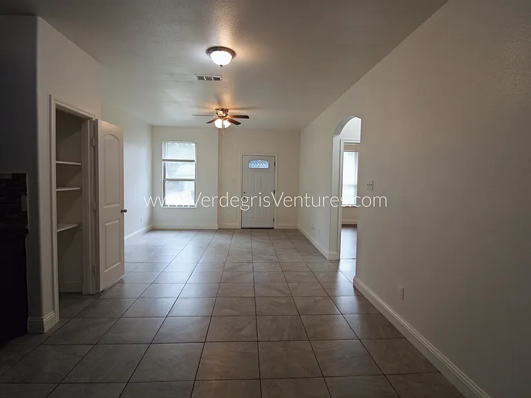 A modern open_concept living, dining, and kitchen area filled with natural light
