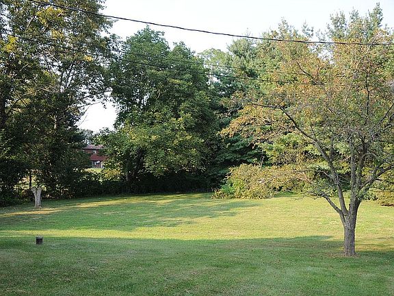 large yard with mature trees