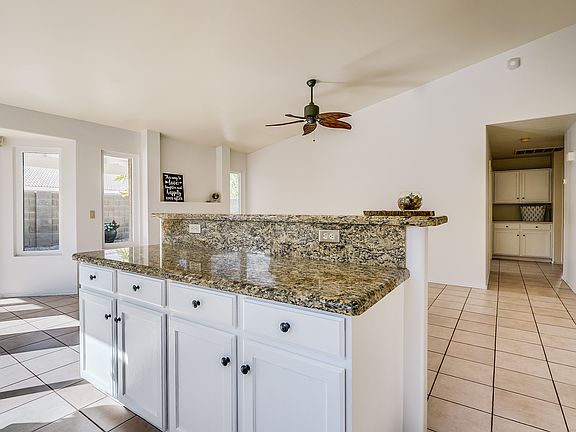 Kitchen has granite & island