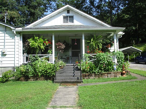 Front of house with carport to the right.