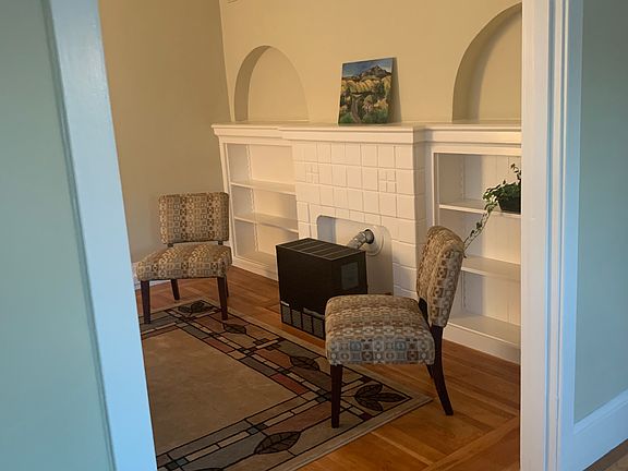 Living area and built in shelving viewed from dining area