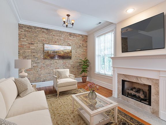 Staged living room shows comfortable furniture placement