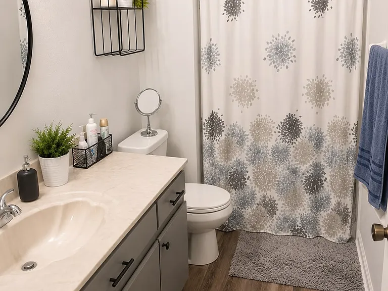 Private primary bathroom with full-size vanity and shower combination.