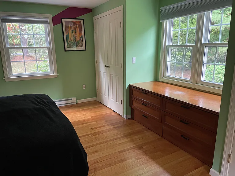 Master bedroom includes 2 closets with built-in drawers and built in dresser between them.