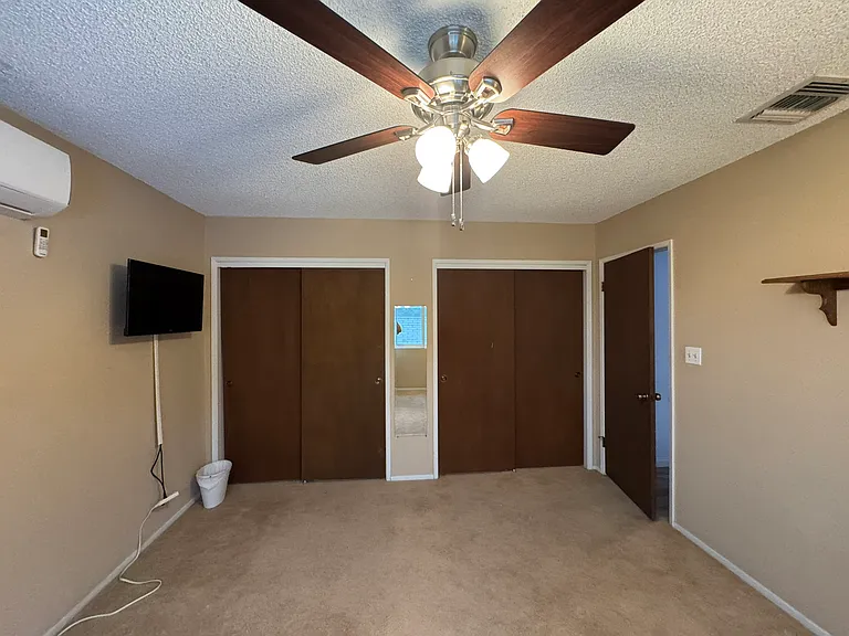 primary bedroom with his and her closets