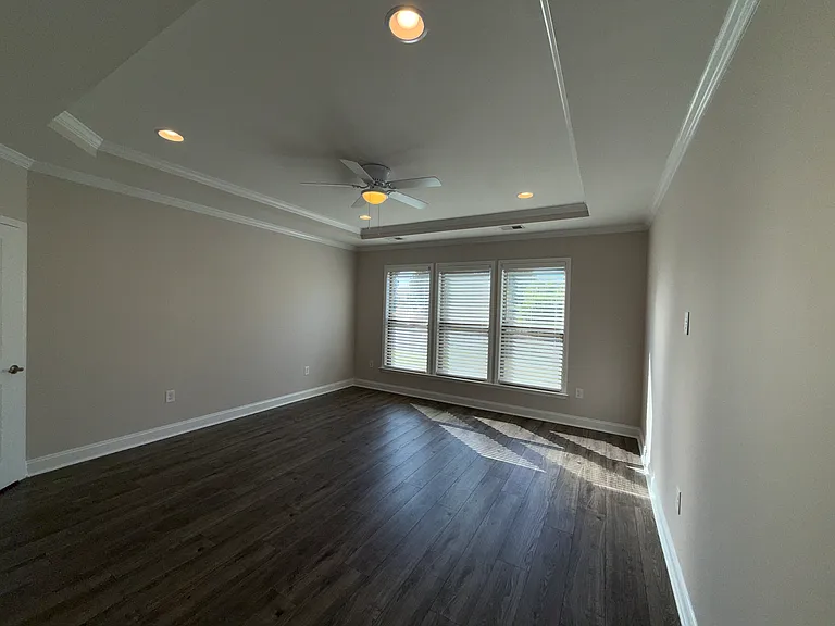 Primary Suite with Tray Ceiling with Recessed Lights and Ceiling Fan