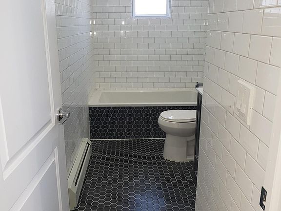 Updated chic floor to ceiling tiled bathroom