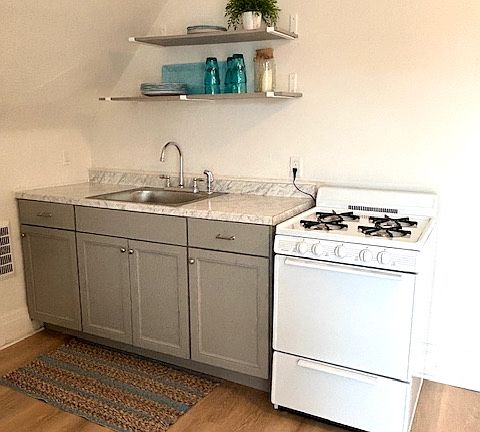 New kitchen cabinetry, countertops, and gas stove