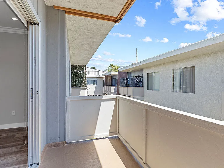 Private balcony with view into communal courtyard.