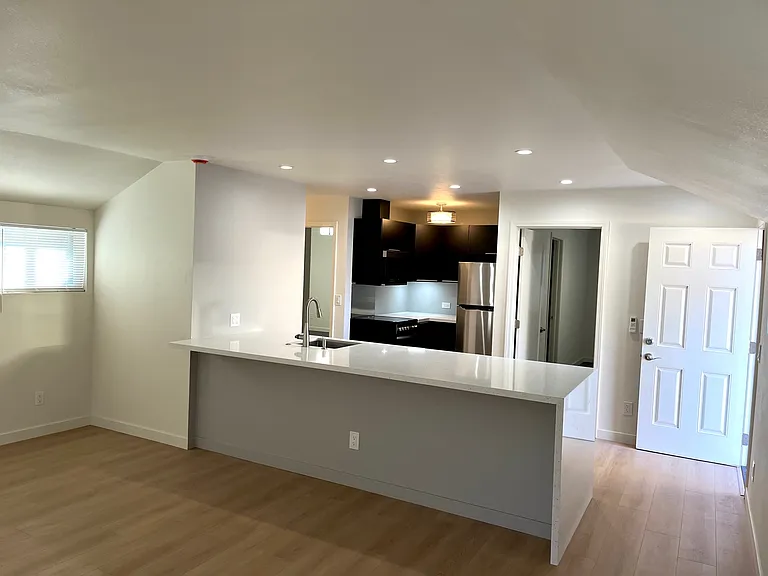 Living room looking towards kitchen & bedroom areas.
Kitchen island bar for casual entertaining.