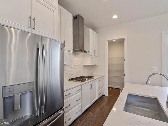 Bright white cabinetry and SS appliances