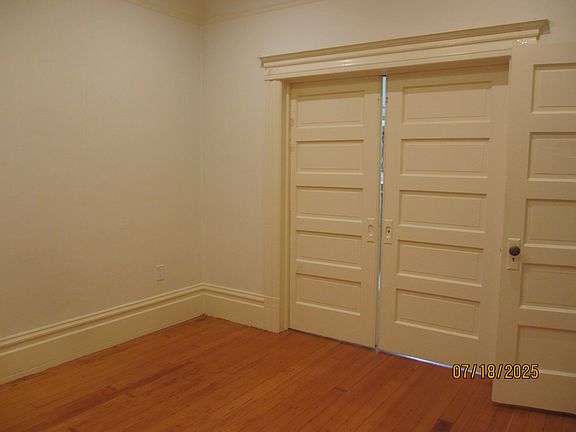 Front bedroon with pocket doors separating the Living room