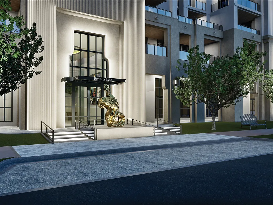 The formal entrance of Regency Parc, distinguished by the sculpture of Lynda Benglis at nighttime.