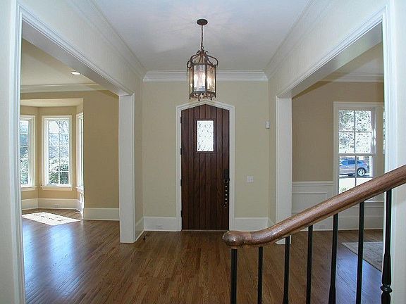 Foyer with ornate wood front door 