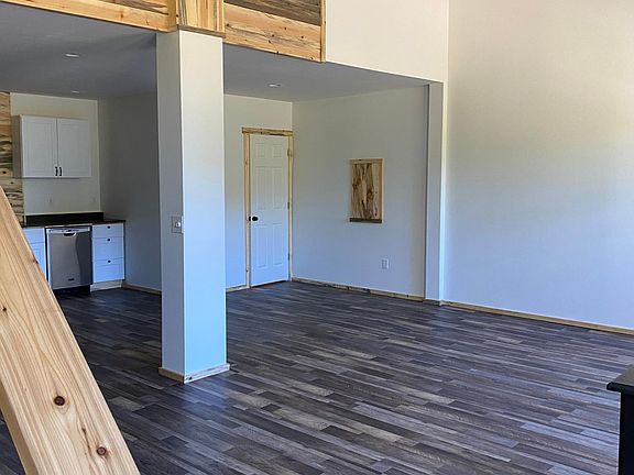 Another angle of the open downstairs floor plan. 1/2 bath in corner