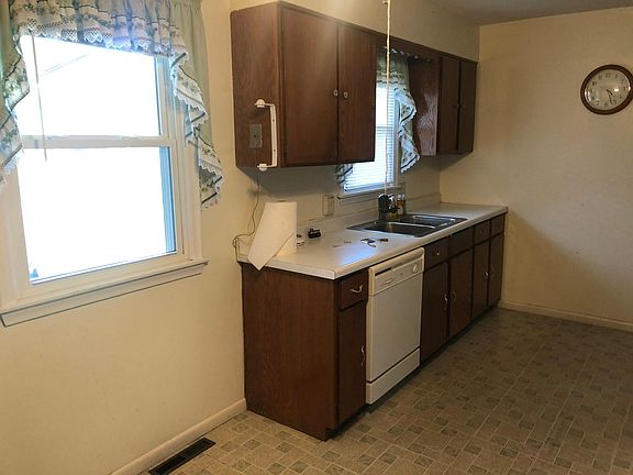 The kitchen overlooks the backyard/park/pond.