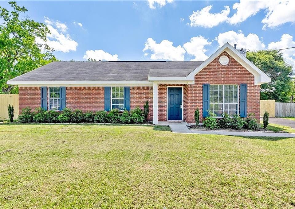 Single story home featuring a front lawn