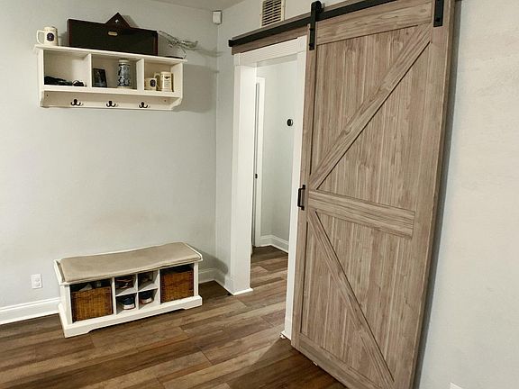 right view from front door - barn door to hallway and bedrooms
