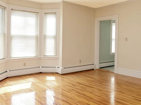 Beautiful bow window, moldings and freshly refinished hardwood floor