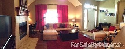 Living Room from Entry
						:
						10ft ceilings, gas starter wood burning fireplace, and neutral paint