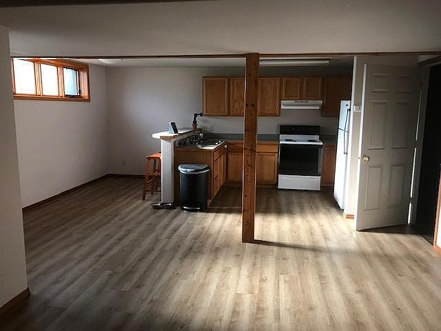 Living Room into Kitchen, countertop seating/kitchen table area, desk area to left.