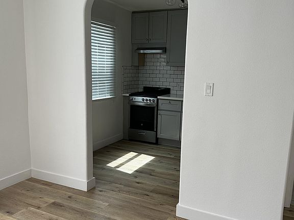 Renovated kitchen with stove, washer/dryer unit, and refrigerator
