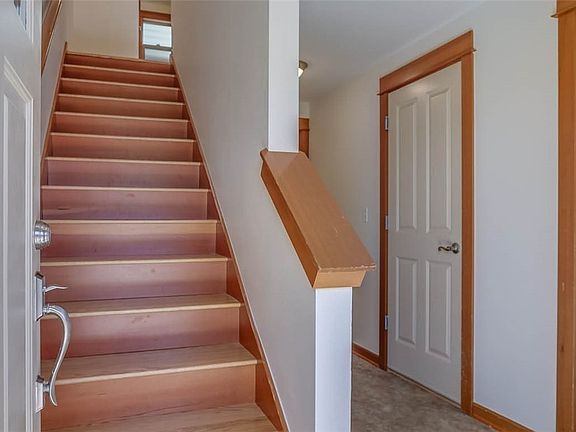 Front entryway with slate tile flooring leads upstairs to main floor living, or this level features bedroom & bathroom. Could be used for private home office or home schooling room.