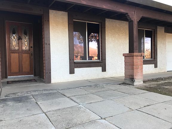 Front entrance with etched and crystal glass door and dining room and kitchen windows.