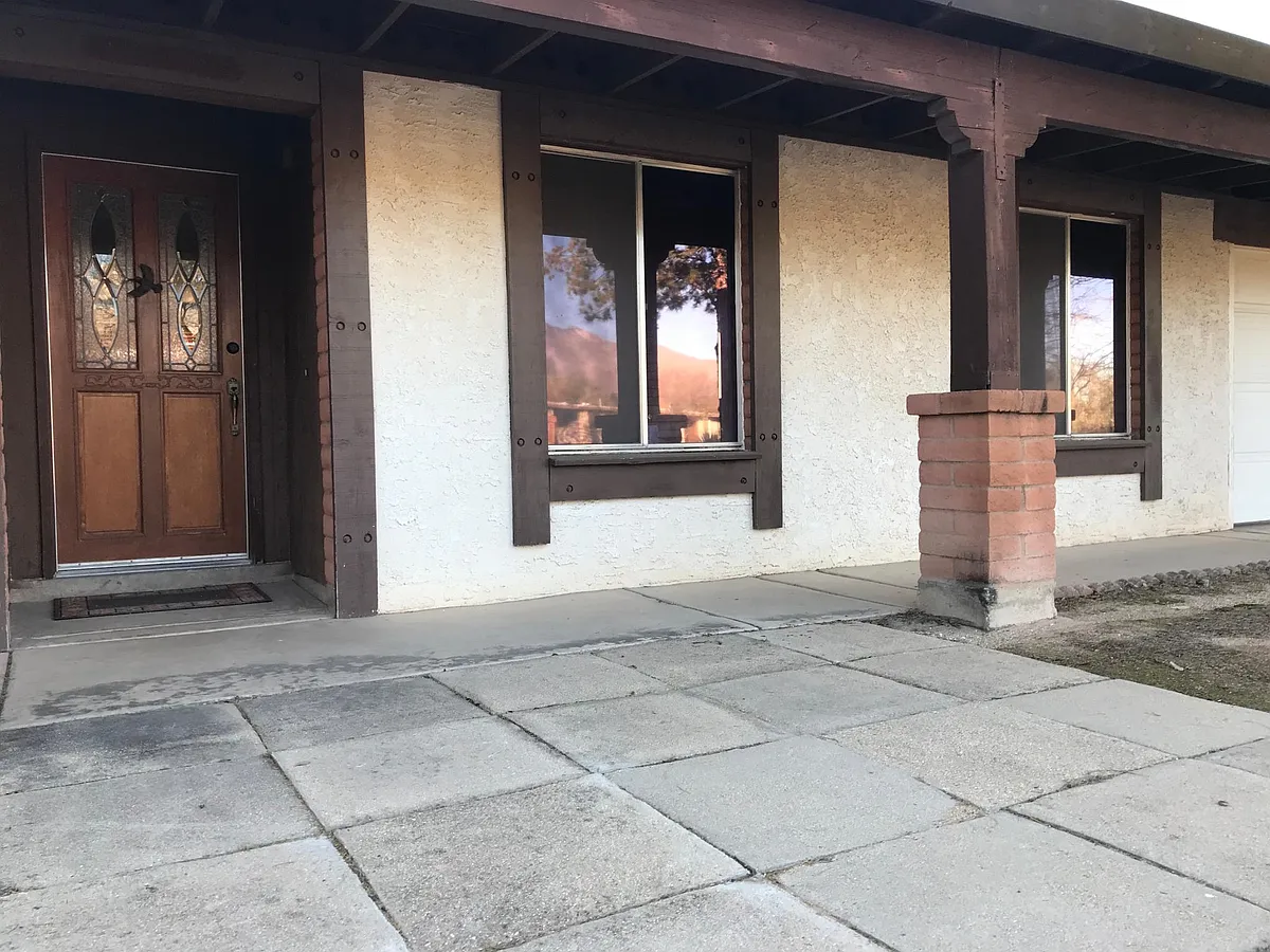 Front entrance with etched and crystal glass door and dining room and kitchen windows. - 9030 E Snyder Rd