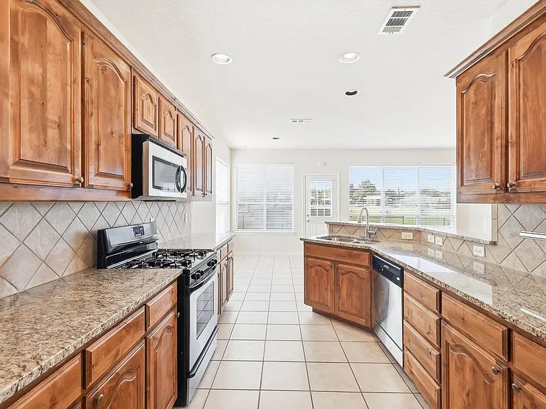 An abundance of cabinetry, countertops. Lots of light and open to breakfast room & back