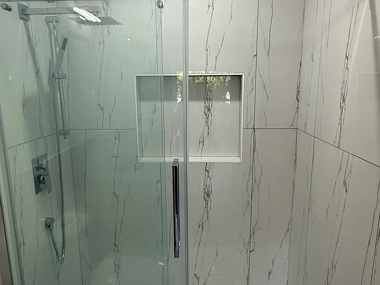 Brand new shower with glass door.