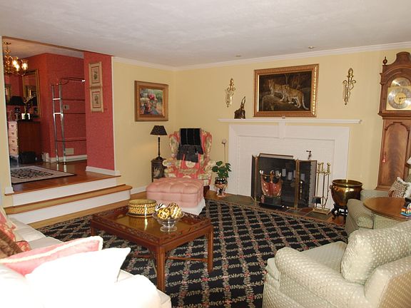 Living Room-Hardwood floor, fireplace, crown molding, French door to deck
