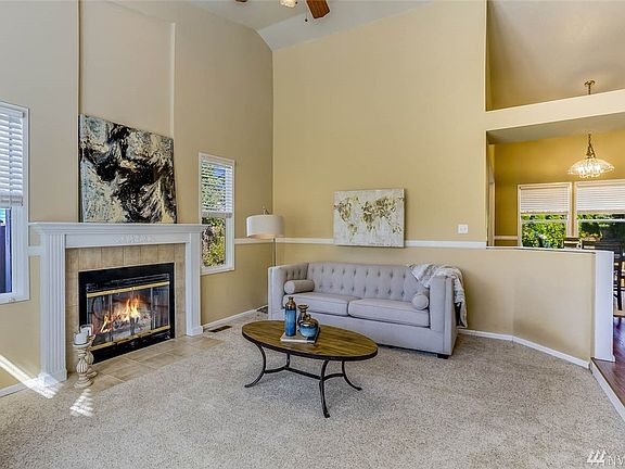 Enter to the formal living room with 2-story vault and cozy wood burning fireplace.