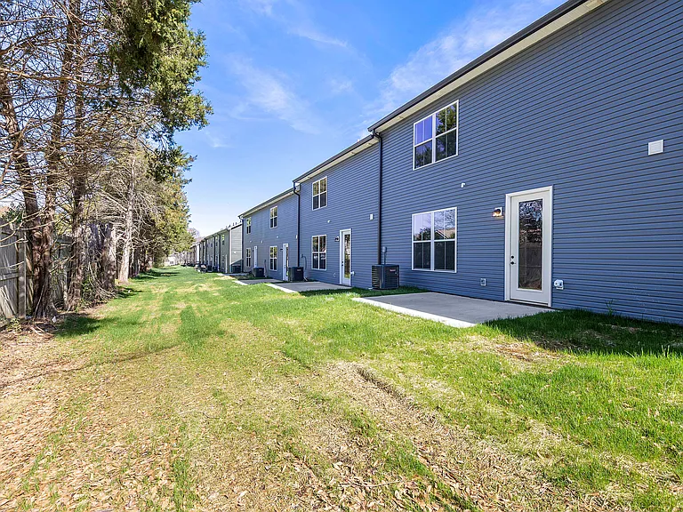 Rear of townhome along treed fence line -- privacy fence along back coming soon!